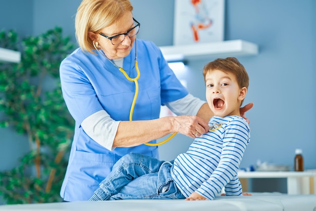 Pediatrician doctor examining little kids in clinic. High quality photo