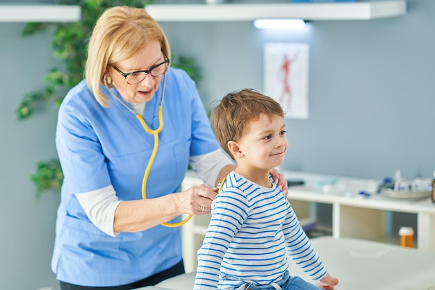 Pediatrician doctor examining little kids in clinic. High quality photo