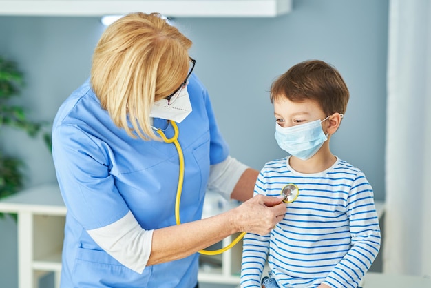 Pediatrician doctor examining little kids in clinic. High quality photo