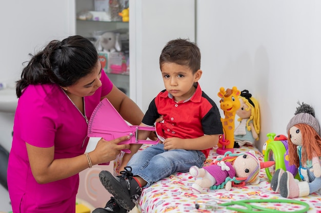 Pediatrician doctor taking measurements of a child with the caliper in her office