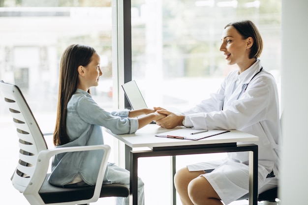 Pediatrician with child having consultation