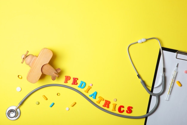 Pediatrics concept stethoscope and toy on a light background