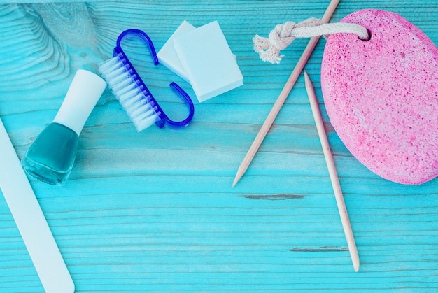 Pedicure accessories with nail polish on wood