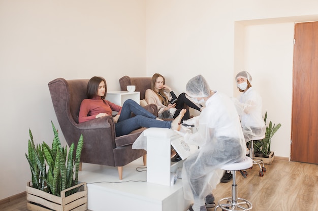 Pedicure in the salon. Master of pedicure doing a procedure for her client. Foot care procedure.