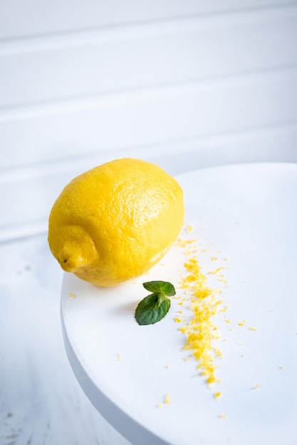 Peel the lemon with a cheese grater lemon zest on white background