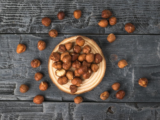 Peeled hazelnuts scattered on a rustic wooden table Flat lay