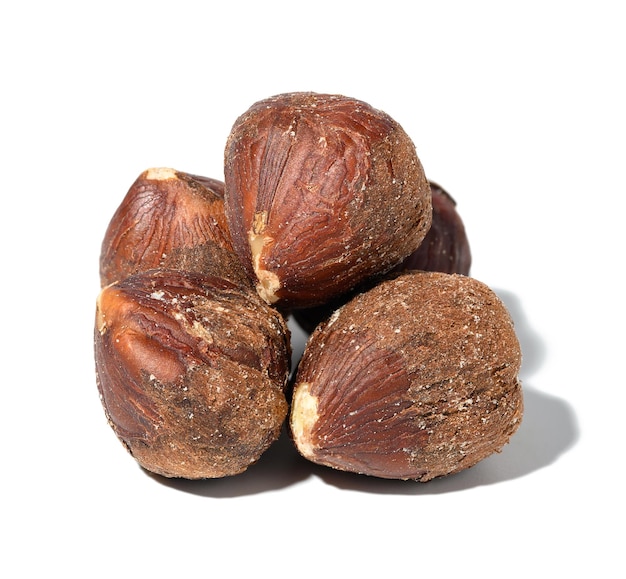 Peeled hazelnuts on a white isolated background