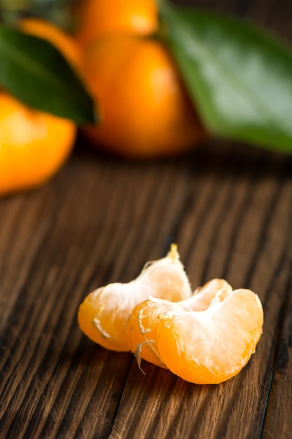 Peeled Mandarin slices on a wooden table