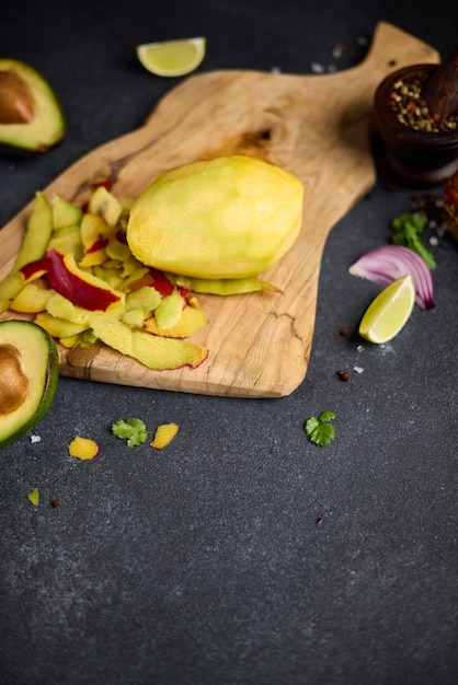 Peeled mango on a wooden cutting board at domestic kitchen