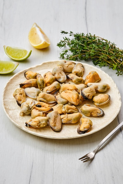 Peeled mussels on ceramic plate