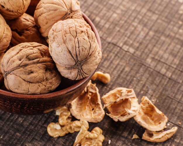 Peeled nuts with shellWalnut kernels and whole walnuts on old wooden