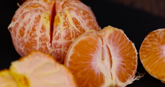 peeled orange tangerines on the table in closeup