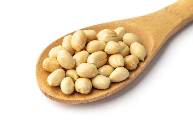 Peeled peanuts in a spoon isolated over white background