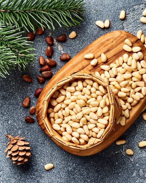 Peeled pine nuts on gray table