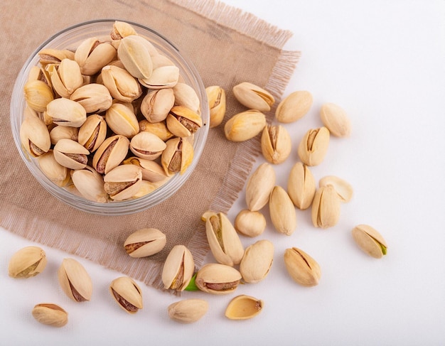 peeled pistachios in a wooden bowl closeup of green peeled pistachio nuts