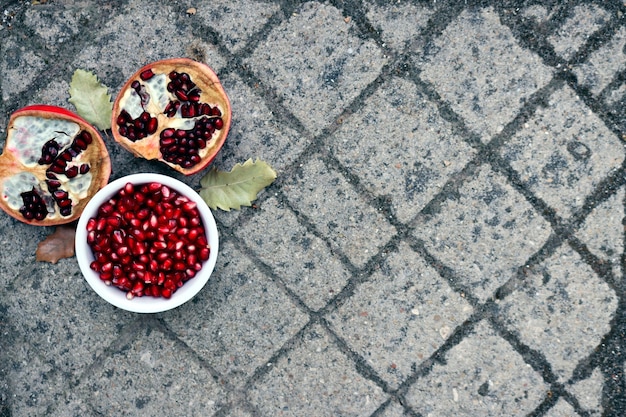 Peeled red pomegranate seeds  on a   gray background