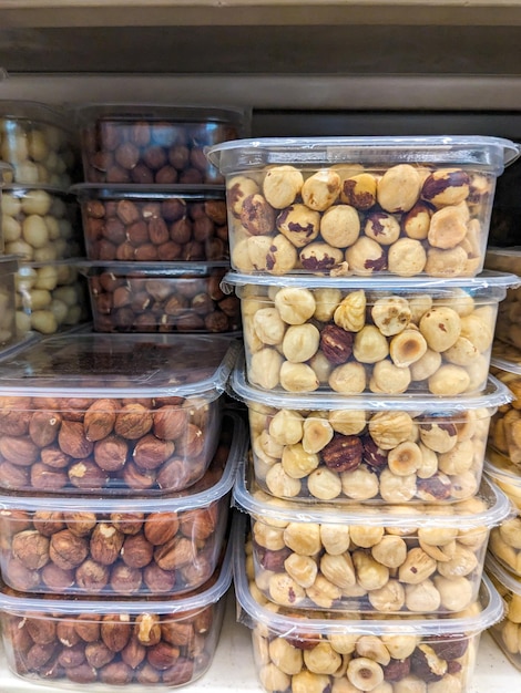 Peeled and unpeeled hazelnuts in plastic packages in the supermarket