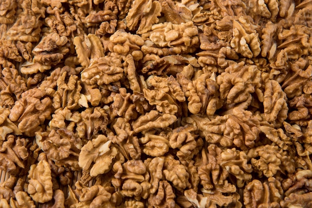 Peeled walnuts as background culinary background copy space