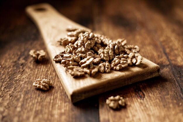 Peeled walnuts On a wooden background Healthy food Natural background