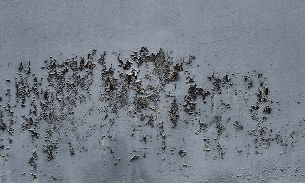 Peeling grey paint on wall seamless texture. Pattern of rustic grey grunge material.