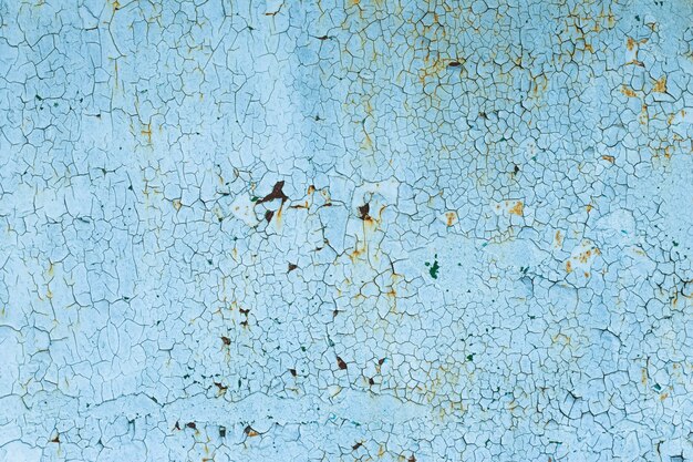 Peeling paint on rusty steel door. Corrosion on a metal surface.