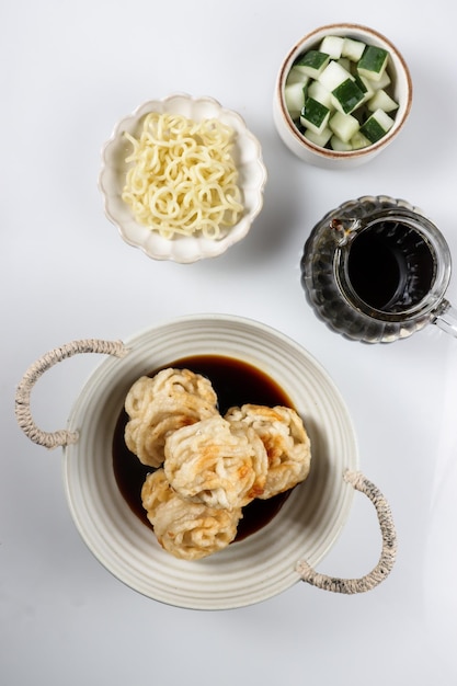 Pempek Keriting or curly fish cake from Palembang, South Sumatera served with cuko.