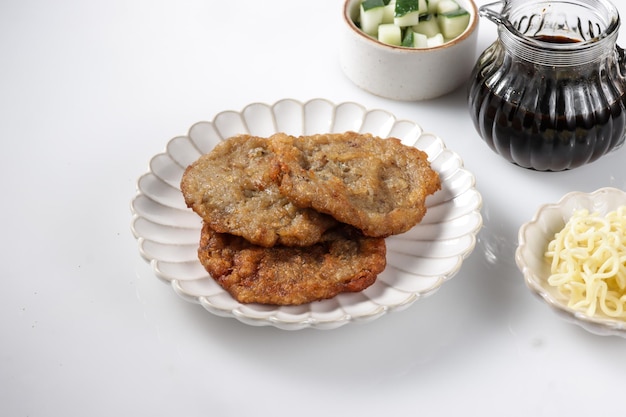 Pempek Kulit is a fish cake, made from fish skin, served with cuko sauce.