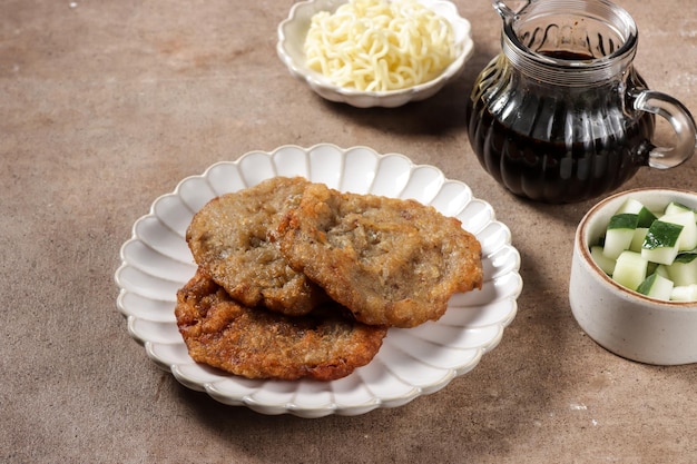 Pempek Kulit is a fish cake, made from fish skin, served with cuko sauce.