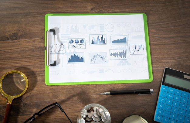 Pen calculator magnifying glass with a financial graphs