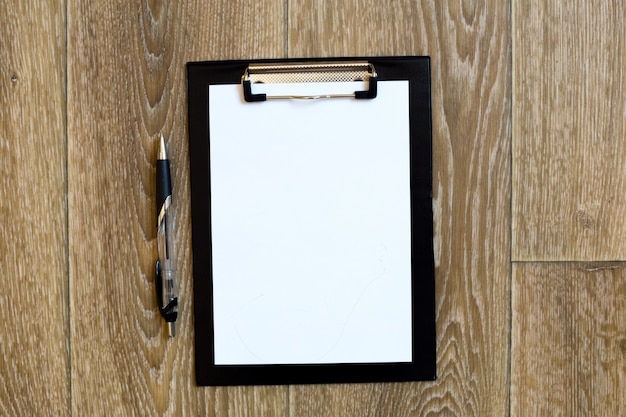 Pen and Notepad on the wooden desk