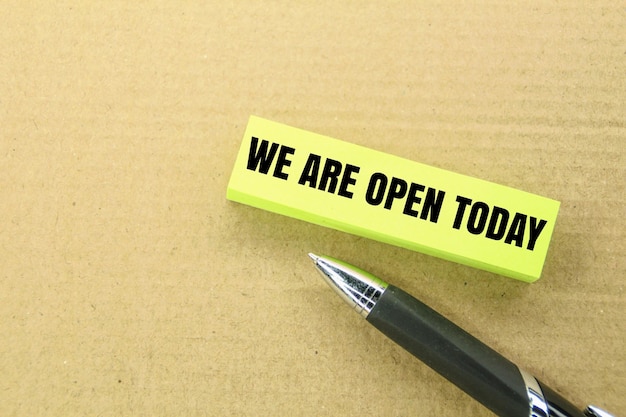 pen and paper with the word wecl are open today open shop concept today