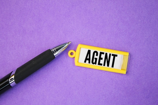 pen and tag with the word agent