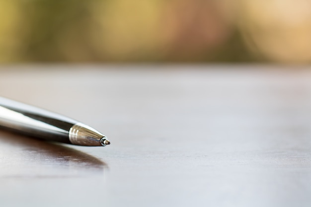 Pen on wooden table.