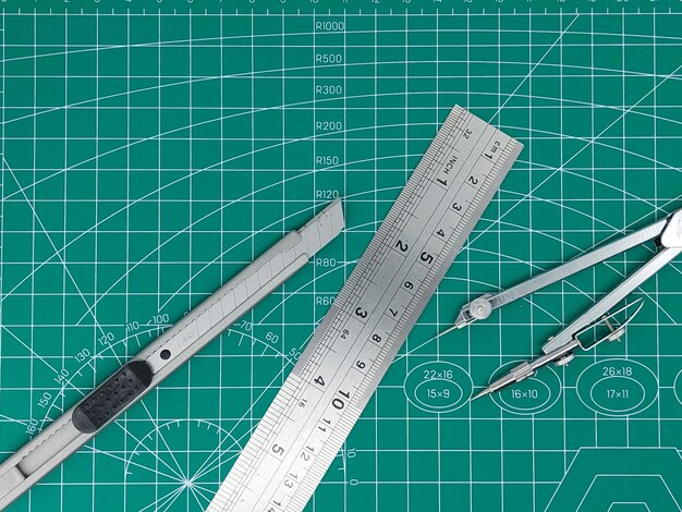 Pencil drawing compass and rulers on cutting mat