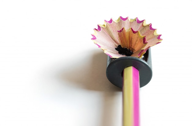 pencil with sharpening shavings on white background