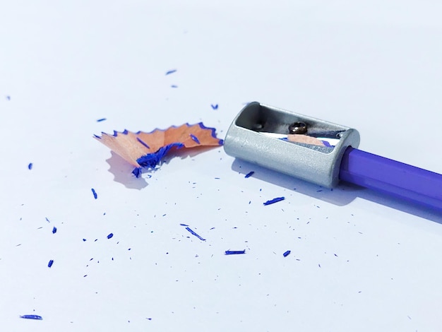 Pencil with sharpening shavings on white background