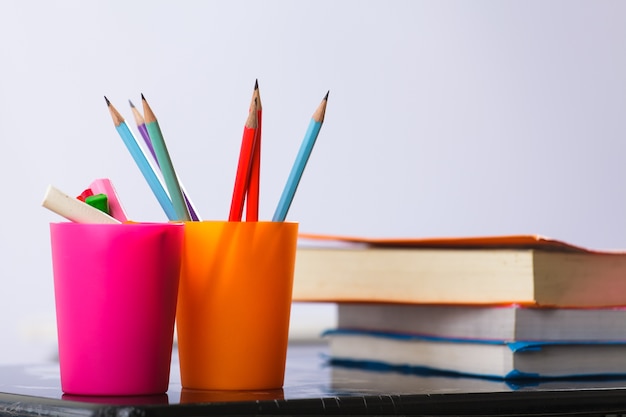 Pencils and book on table 