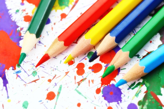 Pencils and paints for drawing in composition on the table