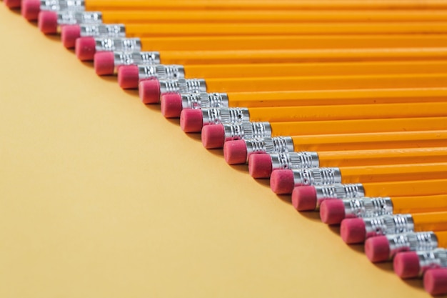 Pencils with rubber arranged evenly in a row