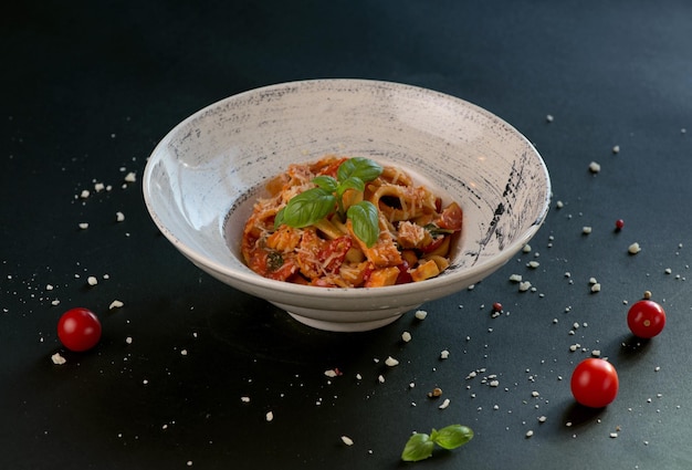 Penne pasta with tomato sauce parmesan cheese and basil on a dark background Top view with copy space