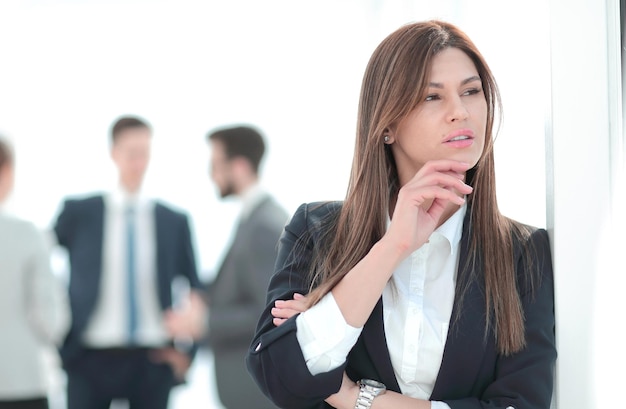 Pensive business woman on blurred office background photo with copy space