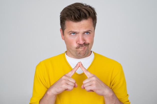 Pensive curious man in thinking pose trying to make choice or decision