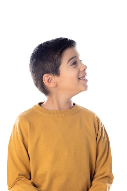 Pensive cute Spanish child with yellow t-shirt isolated on a white background