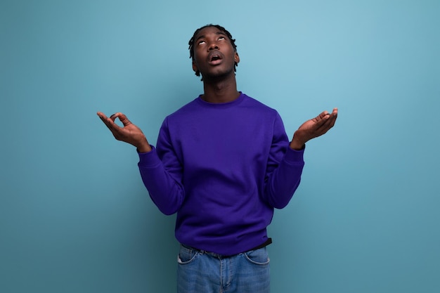 Pensive darkskinned african young man with dreadlocks in casual clothes