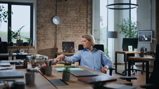 Pensive entrepreneur thinking work sitting empty modern office after workday