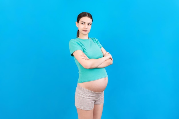 Pensive pregnant woman choosing name for baby on colored background Dream and Happy Pregnant Woman Thinking Imagining Motherhood Life Copy Space