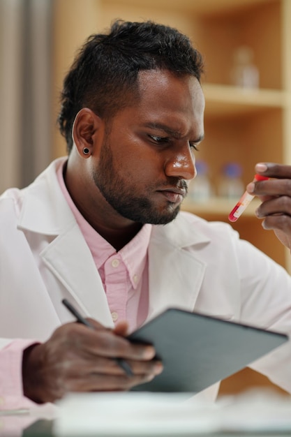 Pensive Scientist Working with Blood Samples