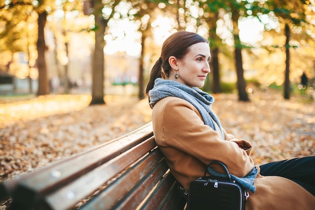 Pensive woman in the autumn park