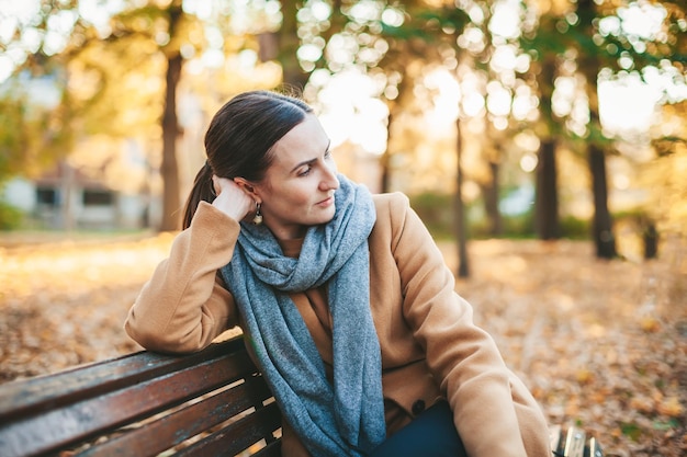 Pensive woman in the autumn park