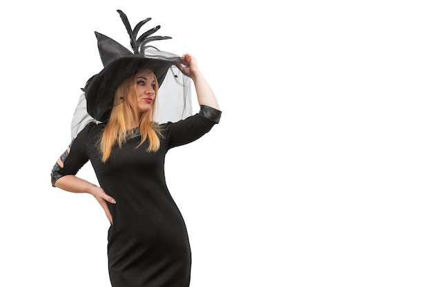 Photo pensive young woman in black witch hat looking to the side space for text mockup copy space halloween party white background